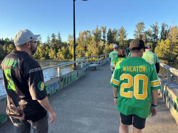 Two guests walk together toward the stadium.