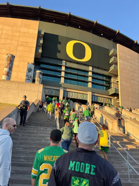 Fans approach an entrance marked with the Oregon O.