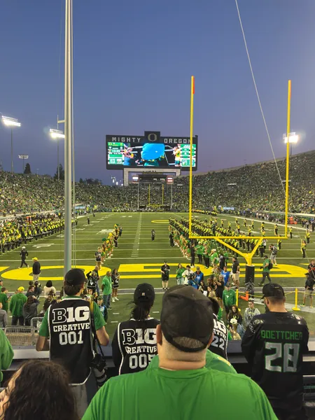 A vertical view of the goalpost, scoreboard, and stands.