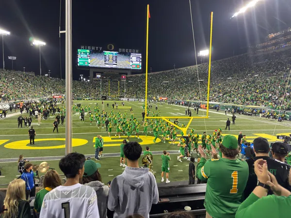 Players and staff gather near the end zone.