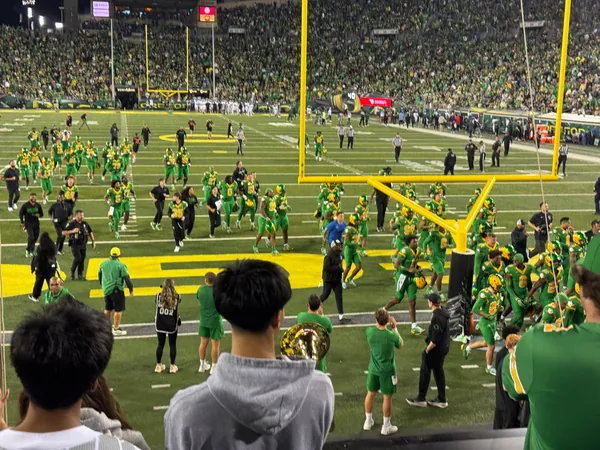 Players and staff cross the end zone after the game.