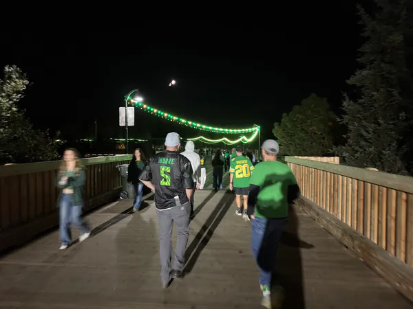 The nighttime walk continues across the bridge.