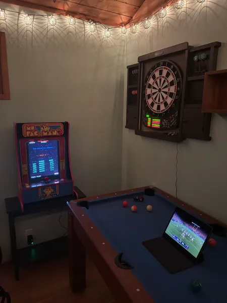 A vertical view of the pool table and dartboard.