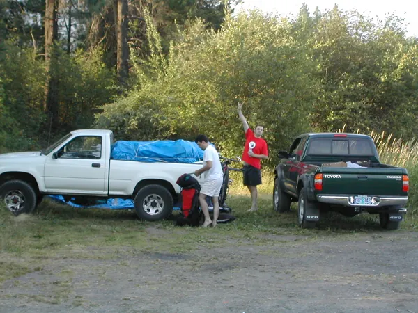 The trip vehicles parked at a wooded stop.