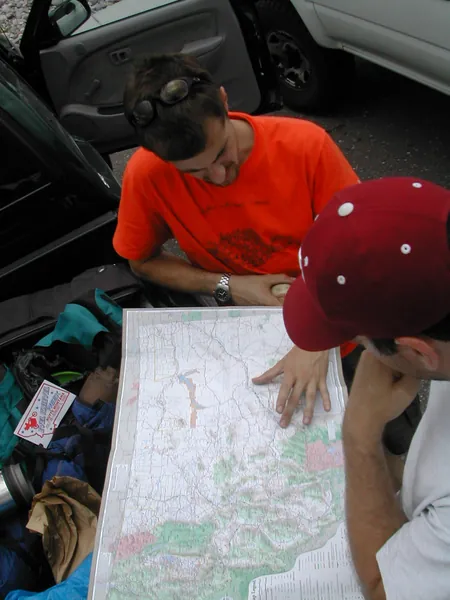 Travelers trace the route across a road map.