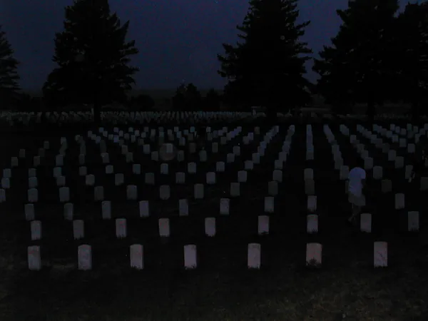 Cemetery markers at dusk.