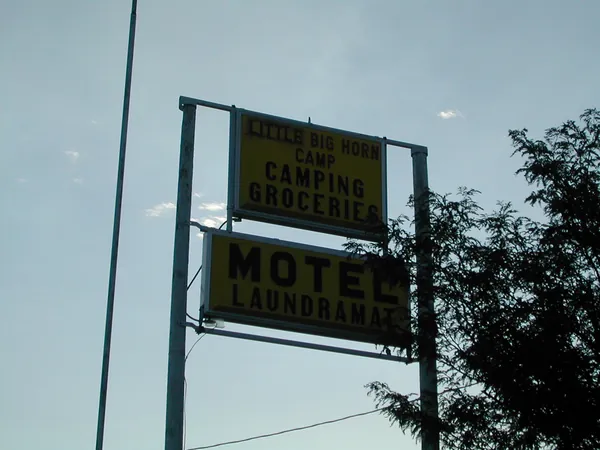 A roadside motel sign at dusk.