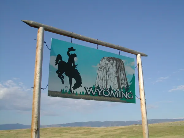 A large Wyoming welcome sign beside the highway.