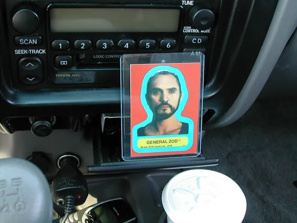 The dashboard card framed by the stereo and cup holders.