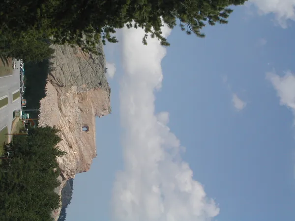 A tilted view of the granite cliffs and blue sky.