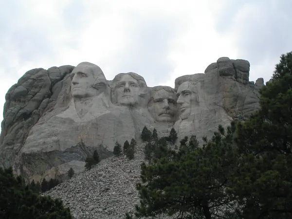 A closer view of Mount Rushmore through the trees.