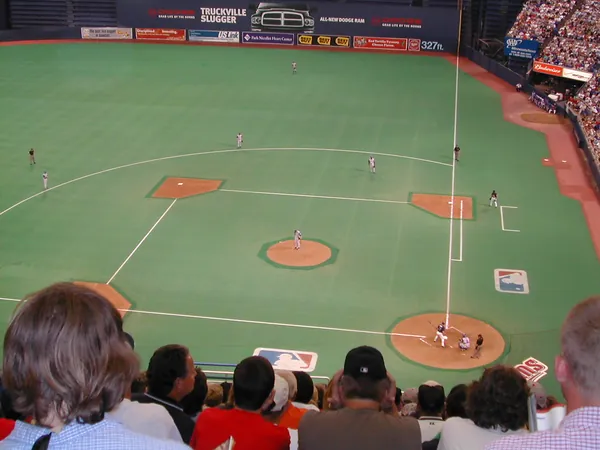 An indoor baseball field viewed from the stands.