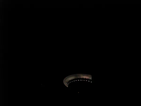 A lit tower rising into the night.