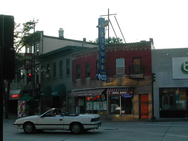 Storefronts and traffic at a city intersection.