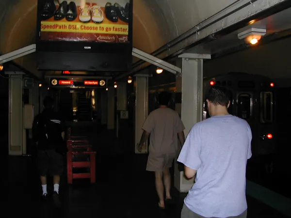 Travelers enter a darkened entertainment venue.