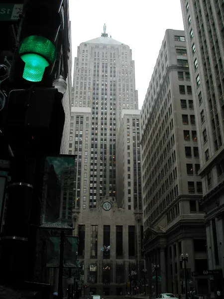 Downtown towers rising above a traffic light.
