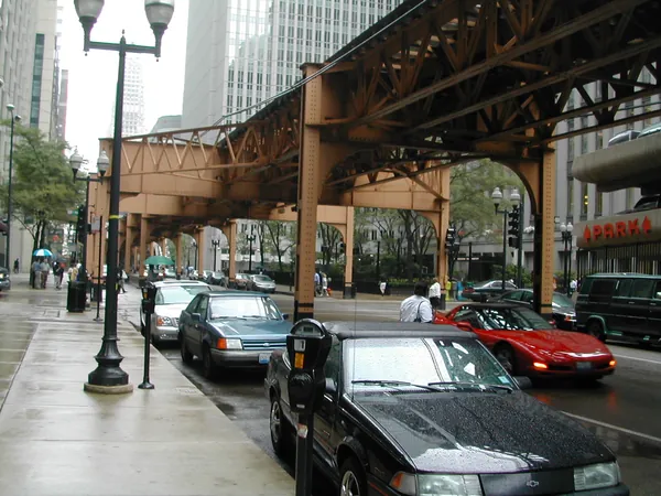 Traffic passing beneath the elevated tracks.