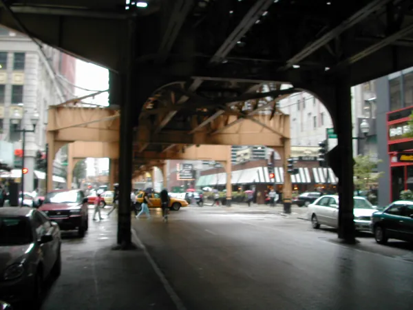 A van approaches beneath the elevated railway.