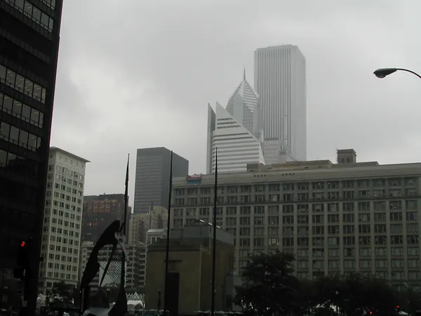 A hazy skyline beyond a large downtown building.