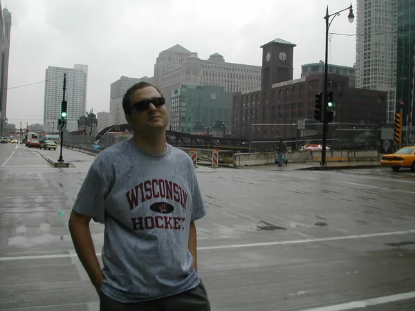 A traveler poses in an open downtown plaza.