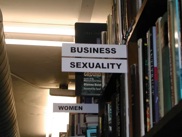 Bookstore shelves divided by category signs.