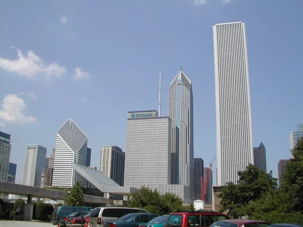 Modern Chicago towers beneath a blue sky.