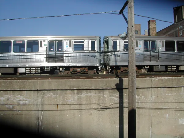 A commuter train passing below street level.