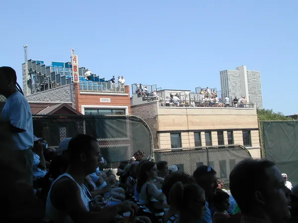 Fans fill the shaded seating area.