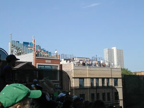 A rooftop crowd overlooking Wrigley Field.
