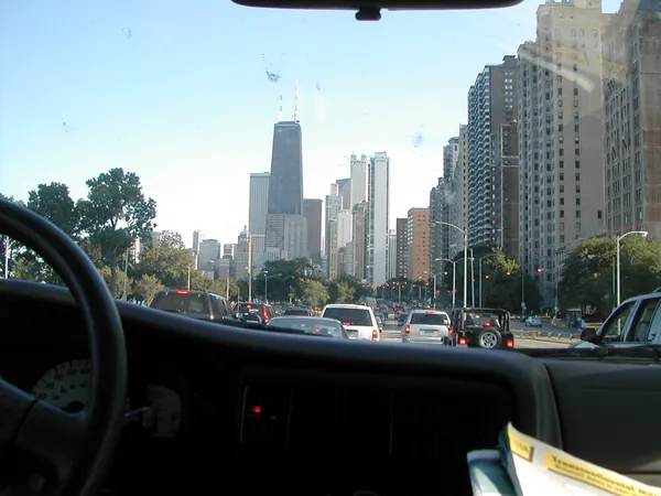 Downtown towers seen through the vehicle windshield.