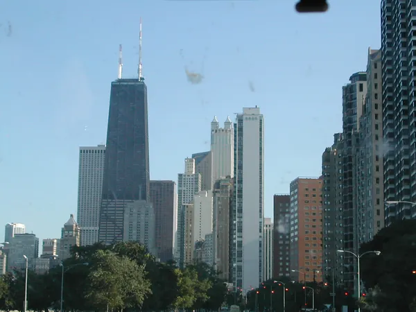 A tall dark tower rising above the roadway.