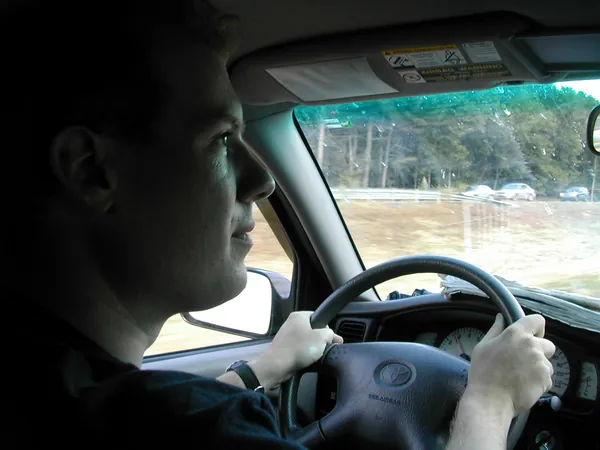 A traveler drives along the highway.