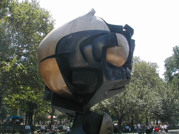 A large globe sculpture in a public plaza.