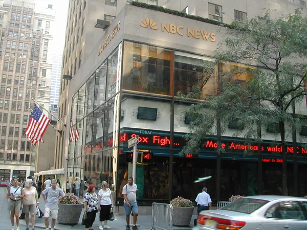 Flags hang above the NBC Studios entrance.