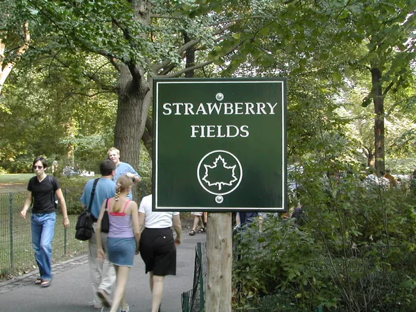 Visitors approach the Strawberry Fields sign.