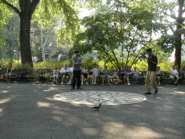 Visitors gather around the memorial mosaic.