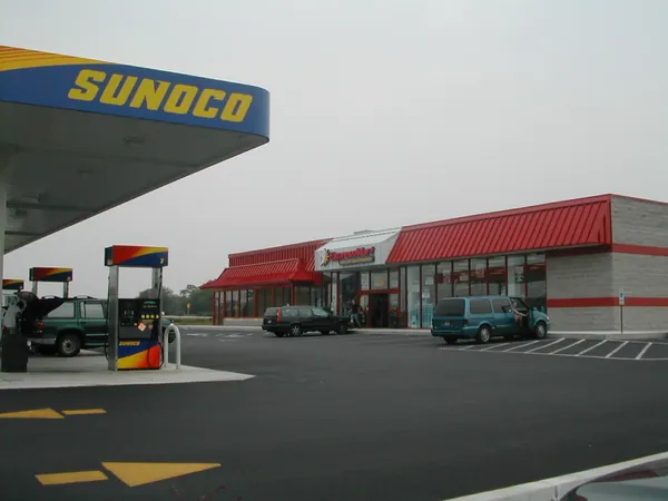 A roadside gas station beneath a gray sky.