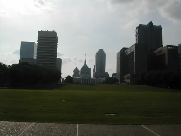 The St. Louis skyline beyond an open lawn.