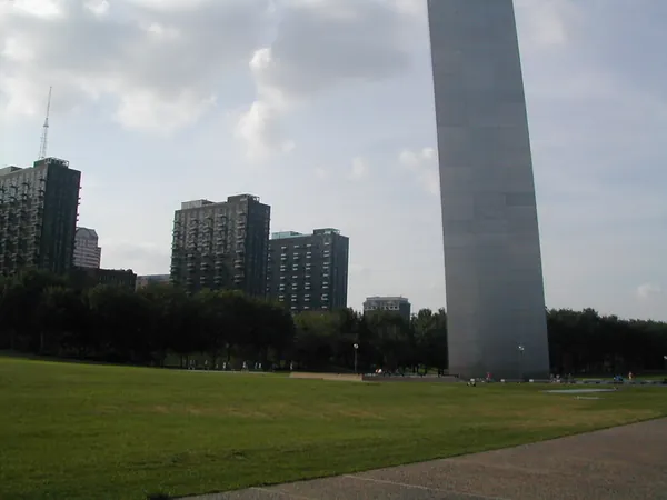 Downtown buildings and the arch across parkland.