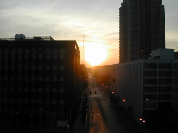 Sunset between downtown buildings.