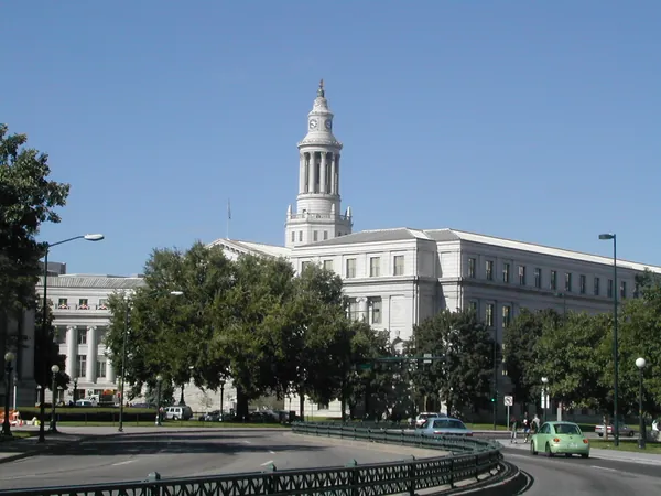 A white civic building with a central tower.