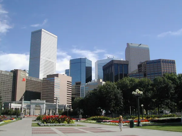 A city skyline beyond a landscaped park.