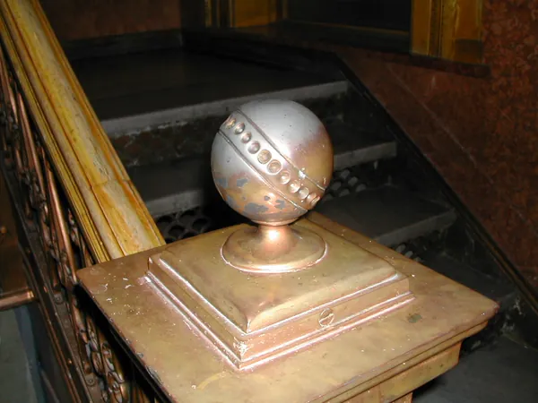 A signed baseball displayed on a pedestal.