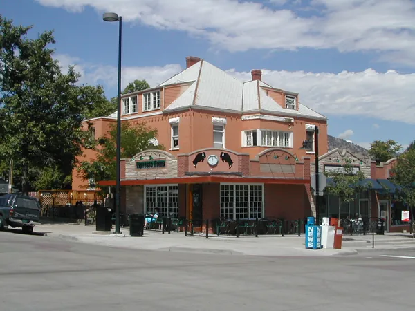 A brick restaurant building on a sunny corner.