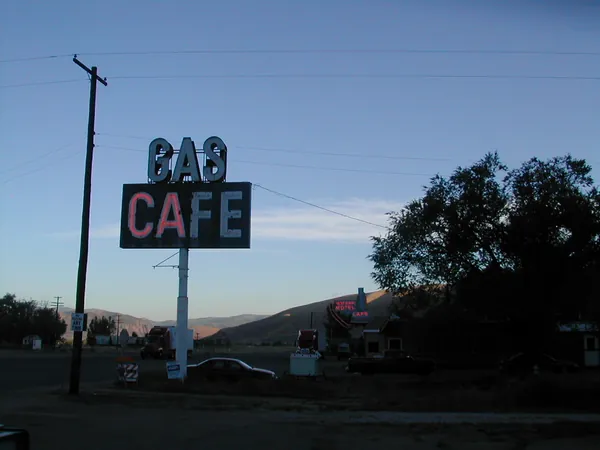 A roadside cafe sign at dawn.
