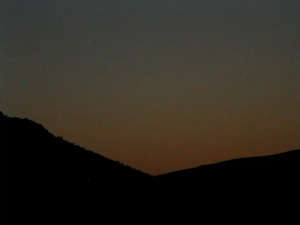 A dark ridgeline beneath the final twilight.